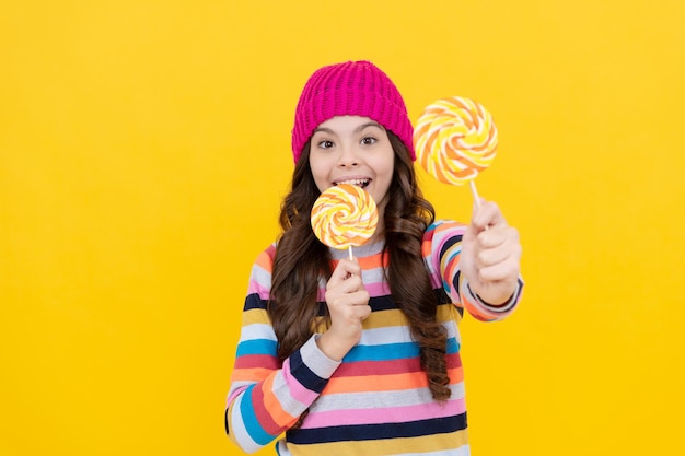 Cheerful teen girl with lollipop candy selective focus eating