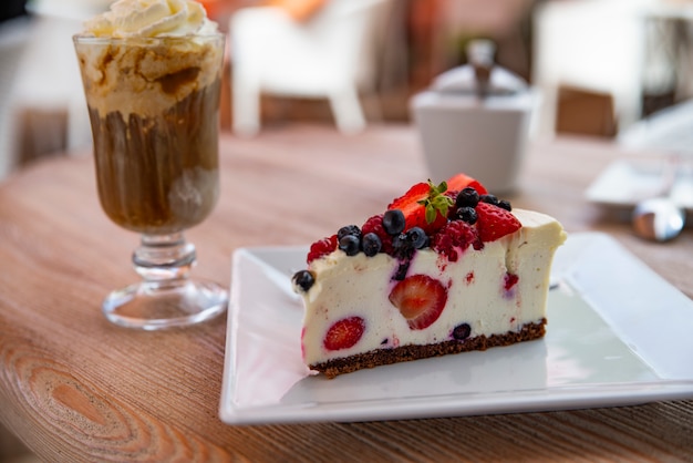 Cheesecake avec des fruits frais et du café glacé