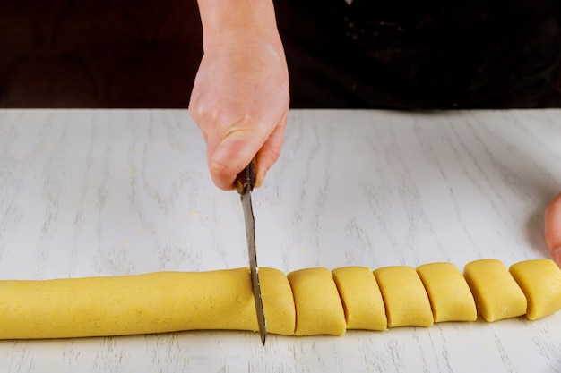 Le chef coupe avec un couteau en portions égales pour cuire des petits pains