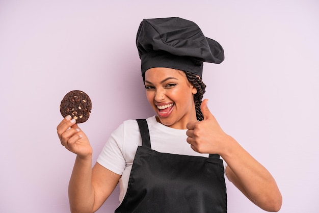 Chef de femme noire afro avec des tresses et faisant un cookie