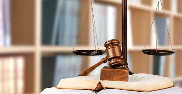 Échelles de justice et livre et marteau en bois sur table. Notion de justice