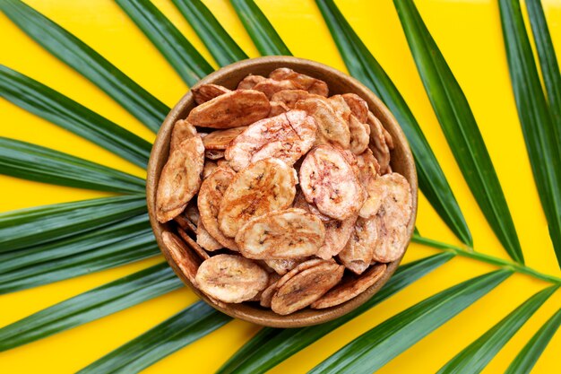 Chips de banane sur congé vert avec surface jaune