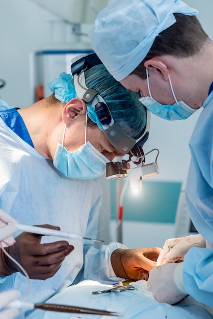 Chirurgie de la colonne vertébrale. Groupe de chirurgiens en salle d'opération avec équipement de chirurgie.