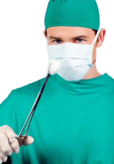 Chirurgien mâle auto-assuré tenant une pince chirurgicale