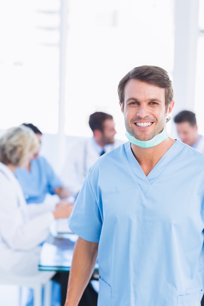 Chirurgien masculin souriant avec des collègues en réunion
