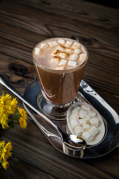 Chocolat chaud avec des guimauves sur une table en bois