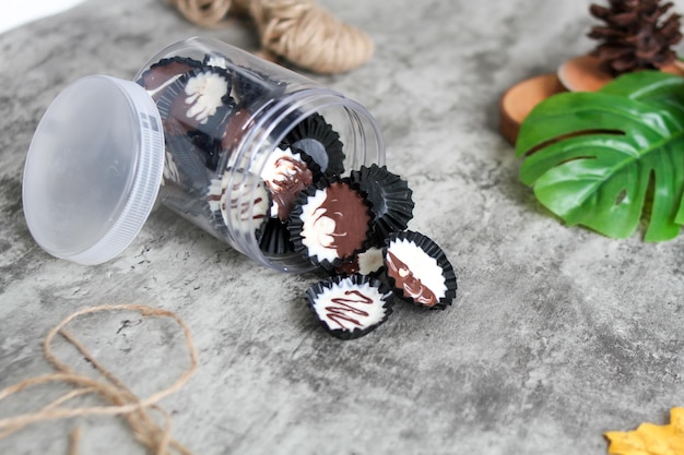 Chocolat noir fait maison et tasse blanche sur une tasse de chocolat en pot transparent avec un fond gris