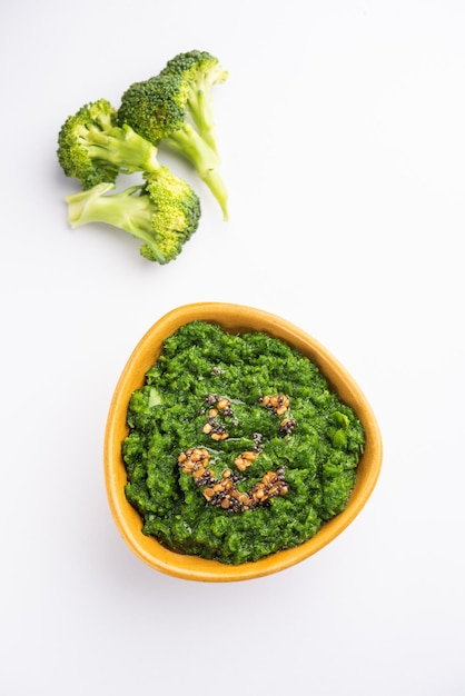 Chutney de brocoli frais ou purée de pâte dans le bol avec des morceaux crus