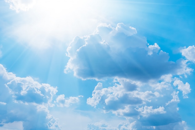 Ciel bleu avec des nuages blancs et du soleil. Fond de la nature