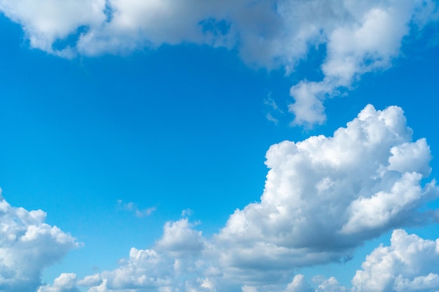 Ciel bleu avec des nuages blancs Soleil nuageux Texture du ciel Arrière-plan Nuages moelleux Motif Cumulus ensoleillé dans l'air bleu avec espace de copie pour le texte