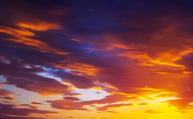 Ciel de coucher de soleil de couleurs ardentes, oranges et rouges. Beau fond