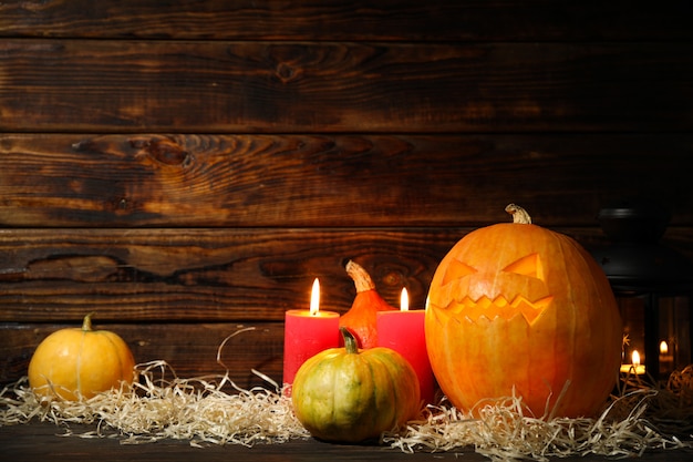 Citrouilles d'Halloween et bougies sur table en bois foncé, espace copie