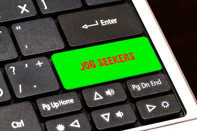 Sur le clavier de l'ordinateur portable, le bouton vert écrit JOB SEEKERS.