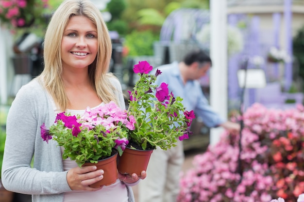 Client tenant des fleurs en souriant