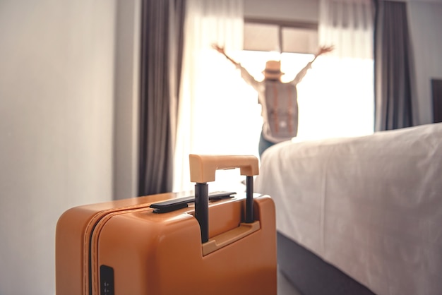 Close-up bagages et fond de femme touriste heureux floue dans l'hôtel après l'enregistrement.