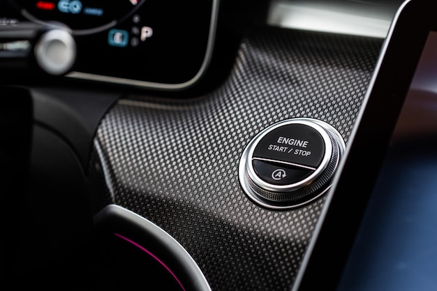 Photo close up bouton d'arrêt du moteur de la voiture détails intérieurs noirs de la voiture moderne