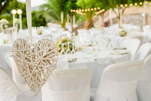 Close-up de la forme d'un cœur contre des chaises lors d'une cérémonie de mariage