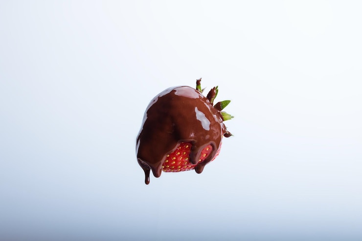 Photo close-up de fraise avec chocolat sur fond blanc
