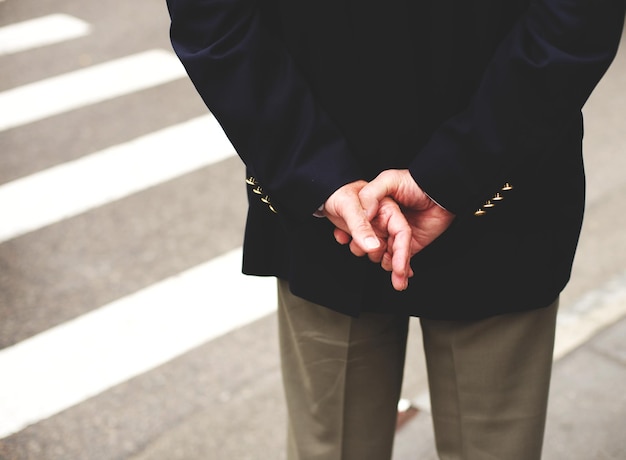 Close-up d'un homme debout avec les mains derrière le dos