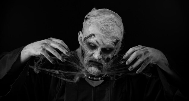 Photo close-up d'un homme avec la peinture du visage sur un fond noir