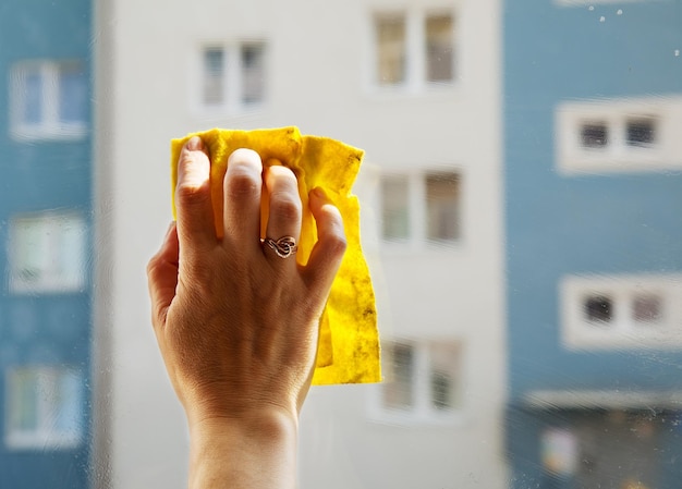 Photo close-up de la main d'une femme sur la fenêtre