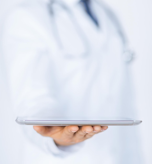 Close up of male doctor holding tablet pc