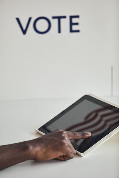 Close-up of man using digital tablet pour voter sur le fond blanc