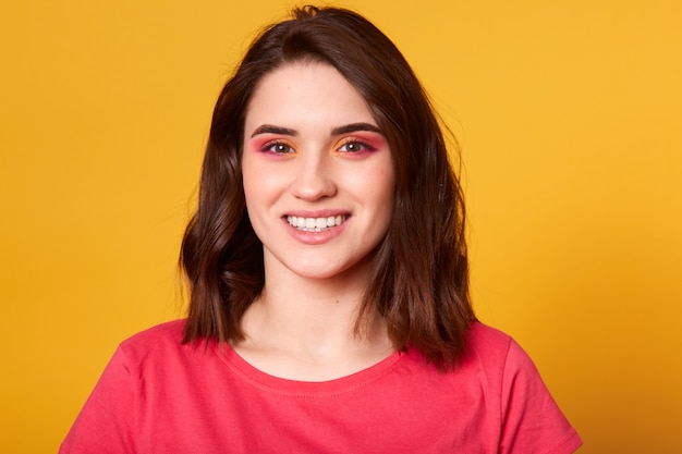 Close up portrait of beautiful caucasian young woman with pink and orange glamour make up
