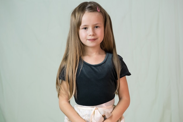 Close-up portrait of happy smiling little girl with long hair.