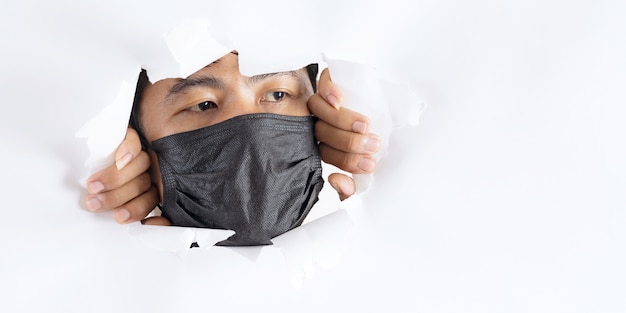 Close-up portrait of man wearing protection face mask against coronavirus