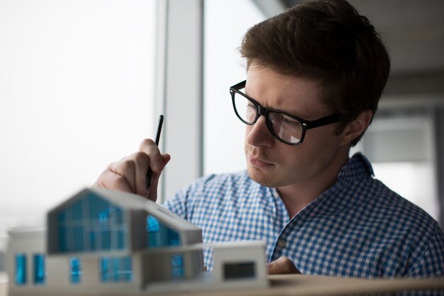 Close up portrait of young pensive architect working project in office