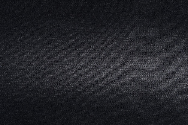 Close-up de la texture du tissu denim noir avec effilochage Matériau pour la fabrication de jeans Arrière-plan pour votre conception