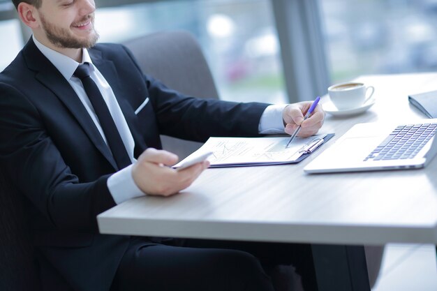 Closeup.businessman vérification des états financiers, assis au bureau dans le bureau