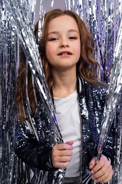 Closeup portrait of a elegant age girl on shiny sparkling wall