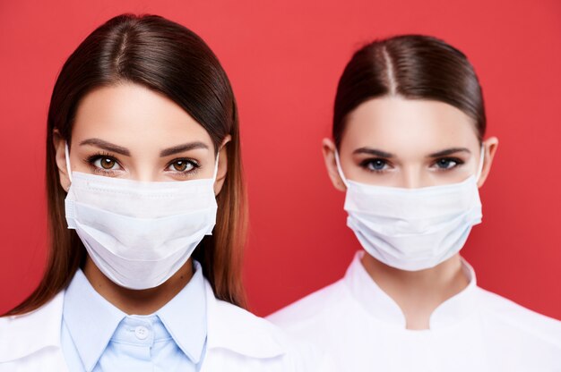 Closeup portrait of two European female doctor's wearing medical mask
