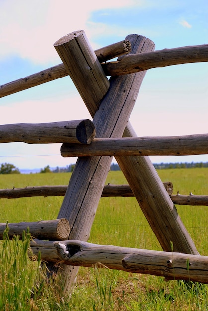 Photo clôture en bois sur un champ agricole contre le ciel