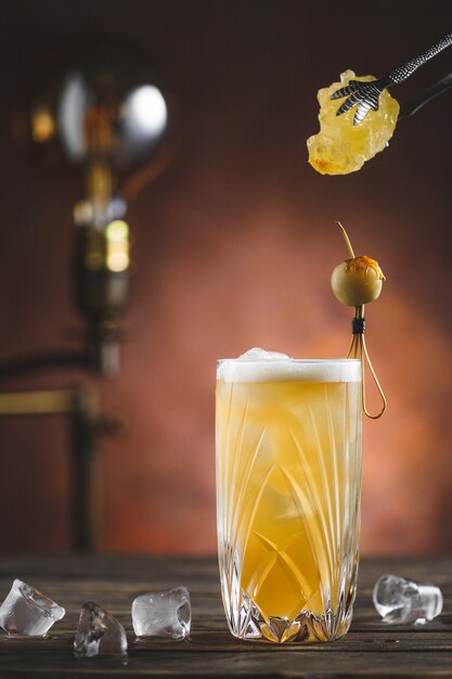 Cocktail avec de la glace sur fond de bois rustique