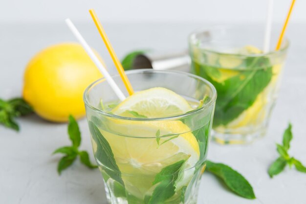 Cocktail rafraîchissant d'été Mojito avec glace et menthe Mojito cocktail au citron vert et menthe dans un grand verre avec un bâton