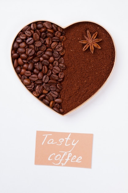 Coeur décoratif de grains de café et poudre d'anis. Isolé sur une surface blanche