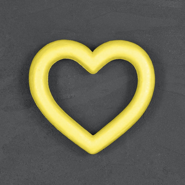 Photo coeur jaune lumineux sur fond gris ultime