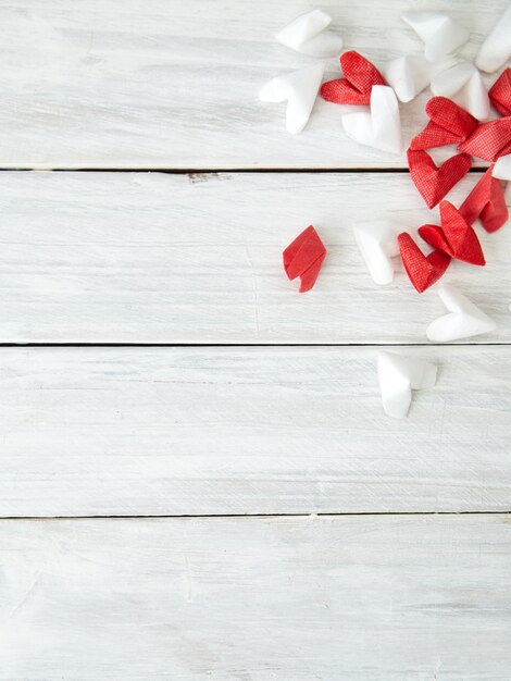 Coeur de papier blanc et rouge sur bois