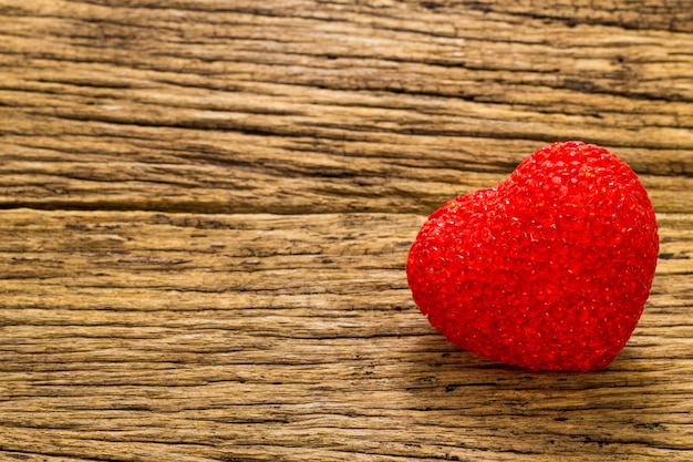 Coeur rouge sur le vieux fond en bois