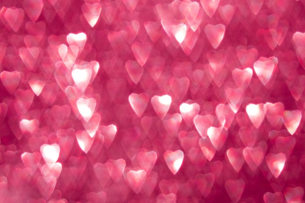 Photo des cœurs roses étincelants bokeh abstrait fond défocalisé pour la fête de la saint-valentin