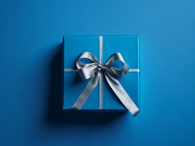 Coffret cadeau bleu avec noeud argenté sur fond bleu Vue de dessus