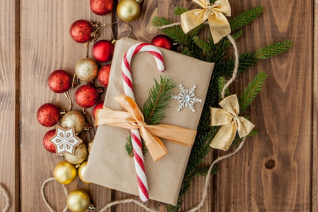 Coffret cadeau de Noël, décoration et branche de sapin sur une table en bois. Vue de dessus avec fond