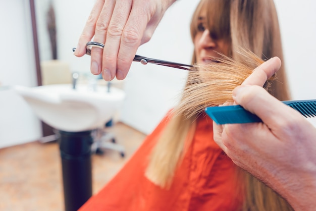 Coiffeur coupe les cheveux du client