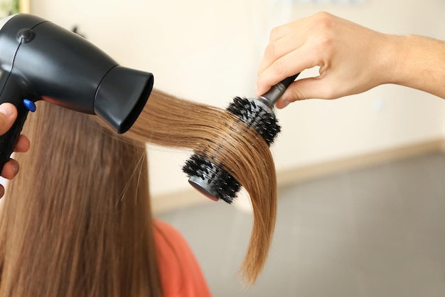 Coiffeur professionnel séchant les cheveux