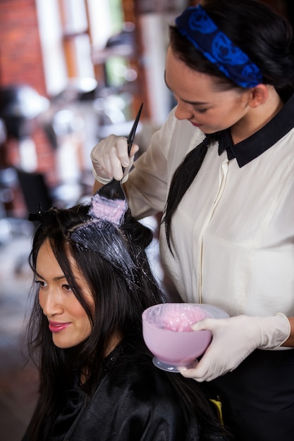 Coiffeur teignant les cheveux de son client