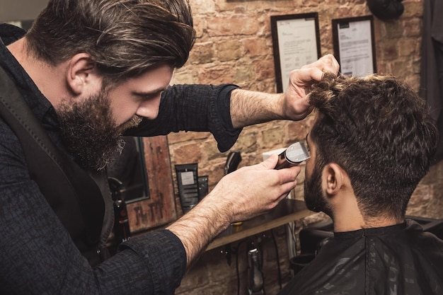 Coiffure pendant le travail avec un client dans le barbier