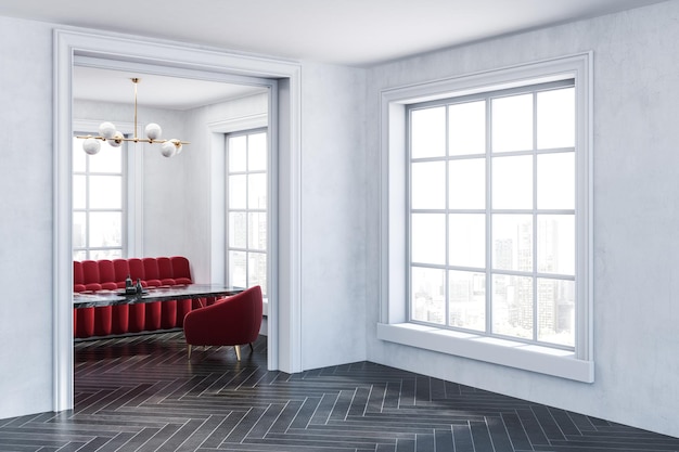 Photo coin de salle blanche vide avec canapé rouge et fauteuils debout près d'une table en marbre noir vue à travers une large porte. rendu 3d